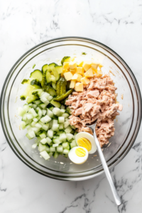 Add pickles, onion, celery, and egg