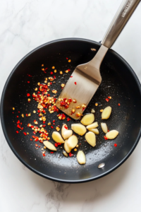 In the same pan, sauté garlic, ginger,