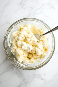 Mixing in mayonnaise, yogurt, and mustard