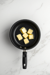 Melt the cold unsalted butter in a small saucepan over low heat.
