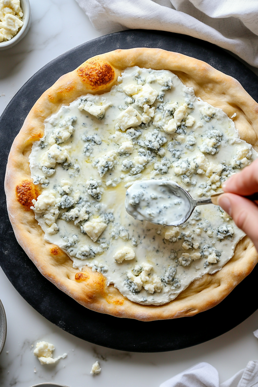 Evenly spread blue cheese salad dressing over the crust.