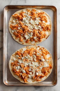 Add the Buffalo chicken mixture evenly on top.