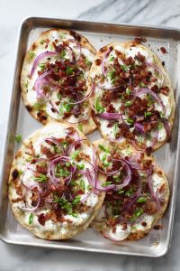 Top with sliced red onions, green onions, and crumbled bacon (optional).