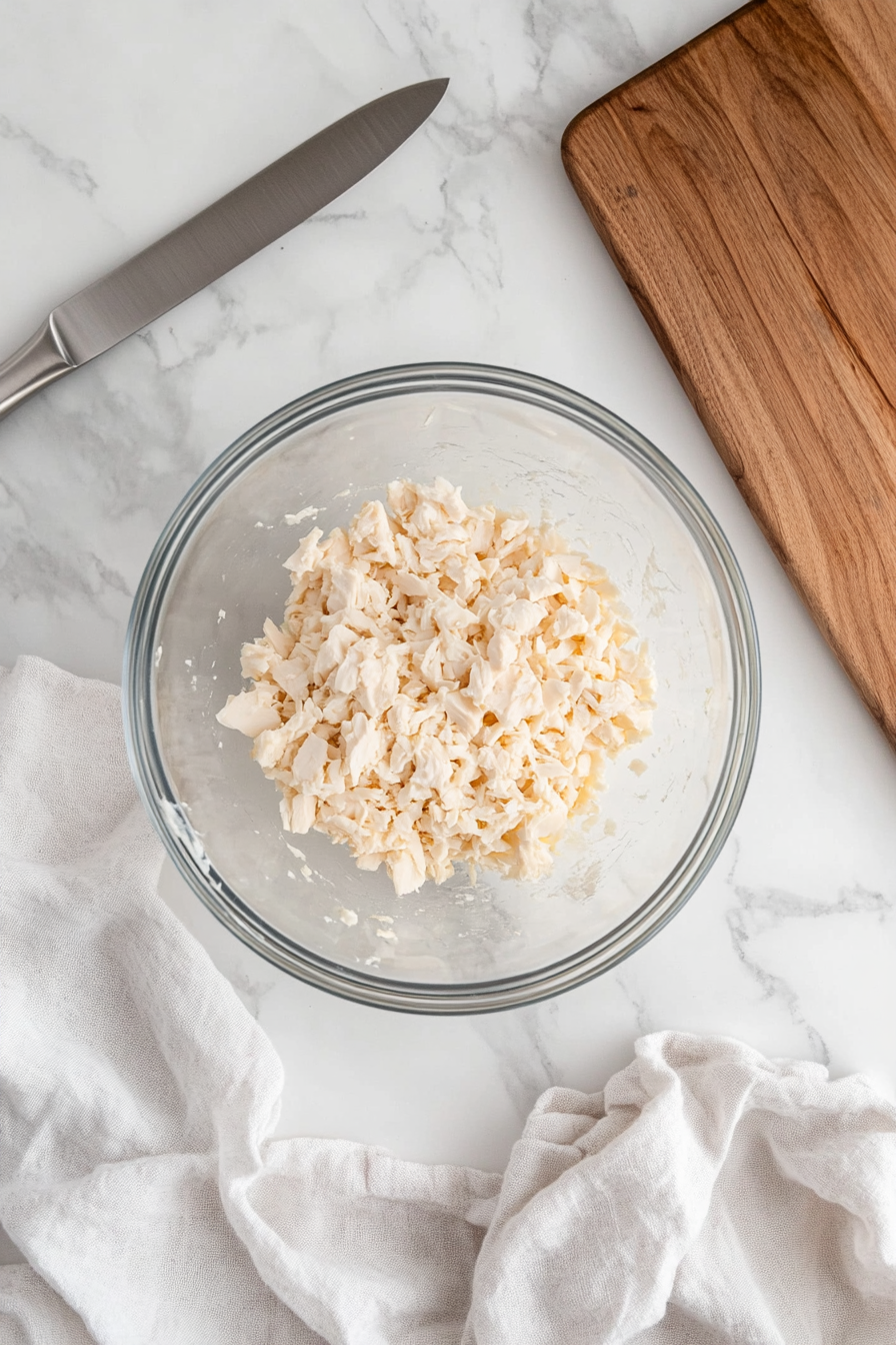 Finely dice the chicken breasts and place them in a mixing bowl.