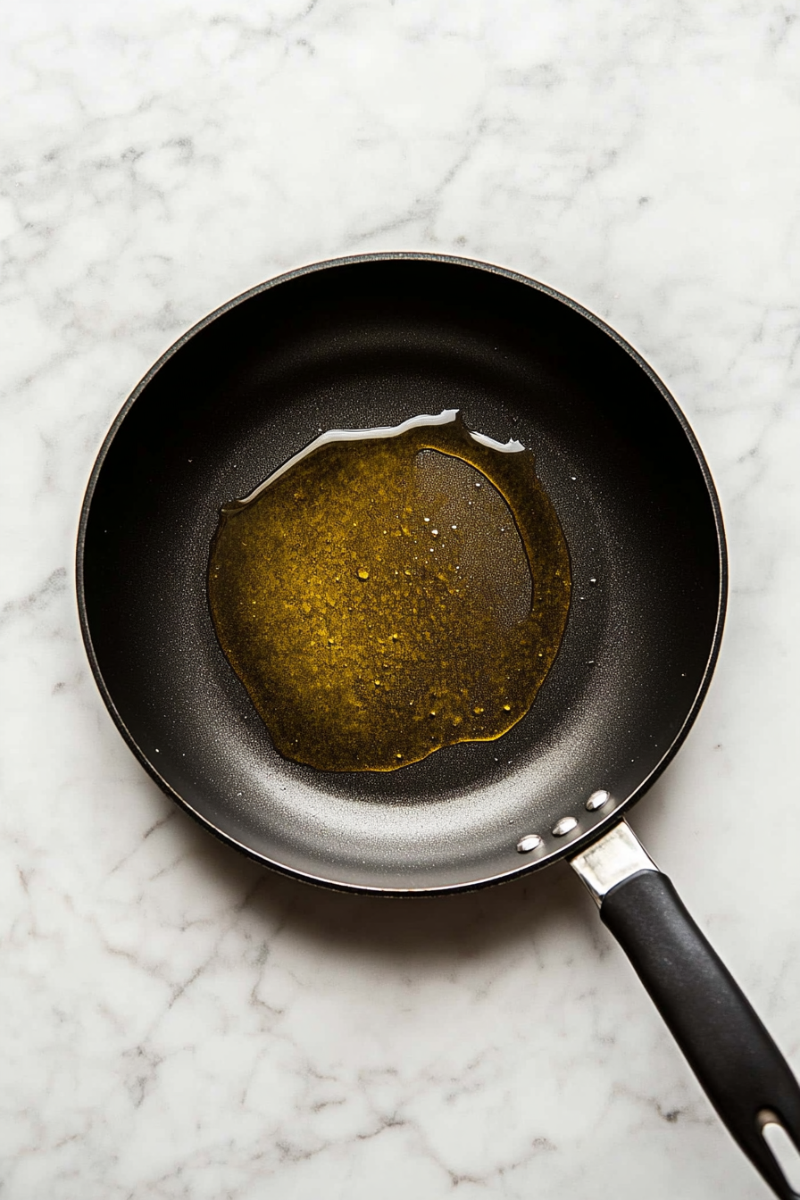 Preheat a skillet over medium heat with olive oil.
