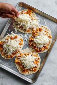 Sprinkle shredded mozzarella over the chicken.