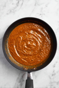 Pour in the masala paste, mix well, and cook until the oil starts to separate.