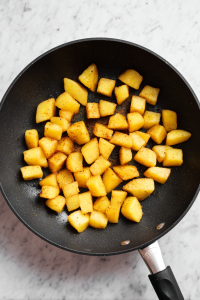 Add diced potatoes and cook until tender. Sprinkle turmeric, salt, and sugar.