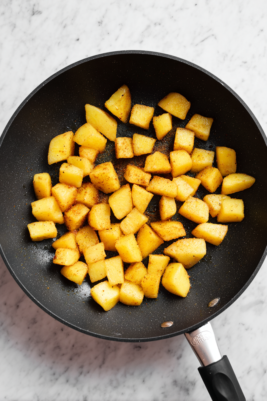 Add diced potatoes and cook until tender. Sprinkle turmeric, salt, and sugar.
