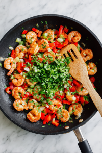 Add chopped shrimp, salt, and chili powder; cook until just pink. Stir in lime juice and cilantro.