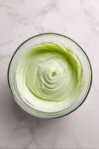 Add butter and mix until crumbly. Then add egg whites, sour cream, oil, and vanilla. Beat until smooth and fluffy.