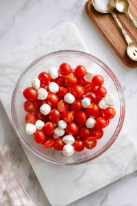 Add the fresh mozzarella pearls to the bowl.