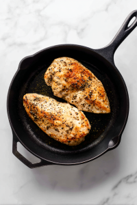 Season chicken breasts with salt and pepper. Heat olive oil in a skillet over medium heat and cook chicken until golden and cooked through.