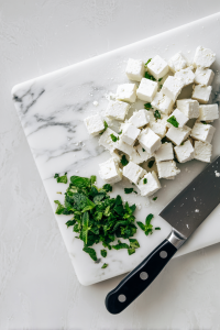 Cube 8 oz of feta cheese and finely mince ½ cup of fresh mint.