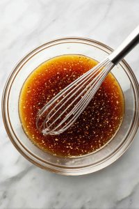 In a bowl, whisk together soy sauce, brown sugar, Worcestershire, pineapple juice, cornstarch, olive oil, ginger, garlic, and crushed red pepper.