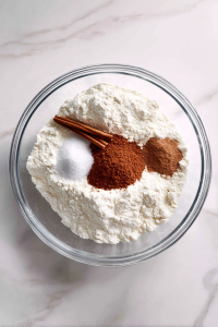 In a bowl, mix flour, baking soda, cinnamon, and salt.