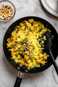 Gently mix in the soaked poha and roasted peanuts. Stir well without breaking it.