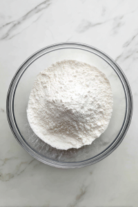 In a bowl, mix flour, sugar, baking powder, and salt.