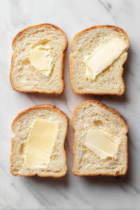 Lightly butter one side of each bread slice.