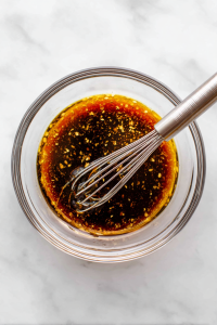 Meanwhile, in a small bowl, mix soy sauce, rice vinegar, chili oil, minced garlic, sugar, and sesame oil.