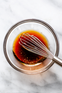In a separate small bowl, whisk together red wine vinegar, olive oil, Dijon mustard, honey (if using), salt, and pepper.
