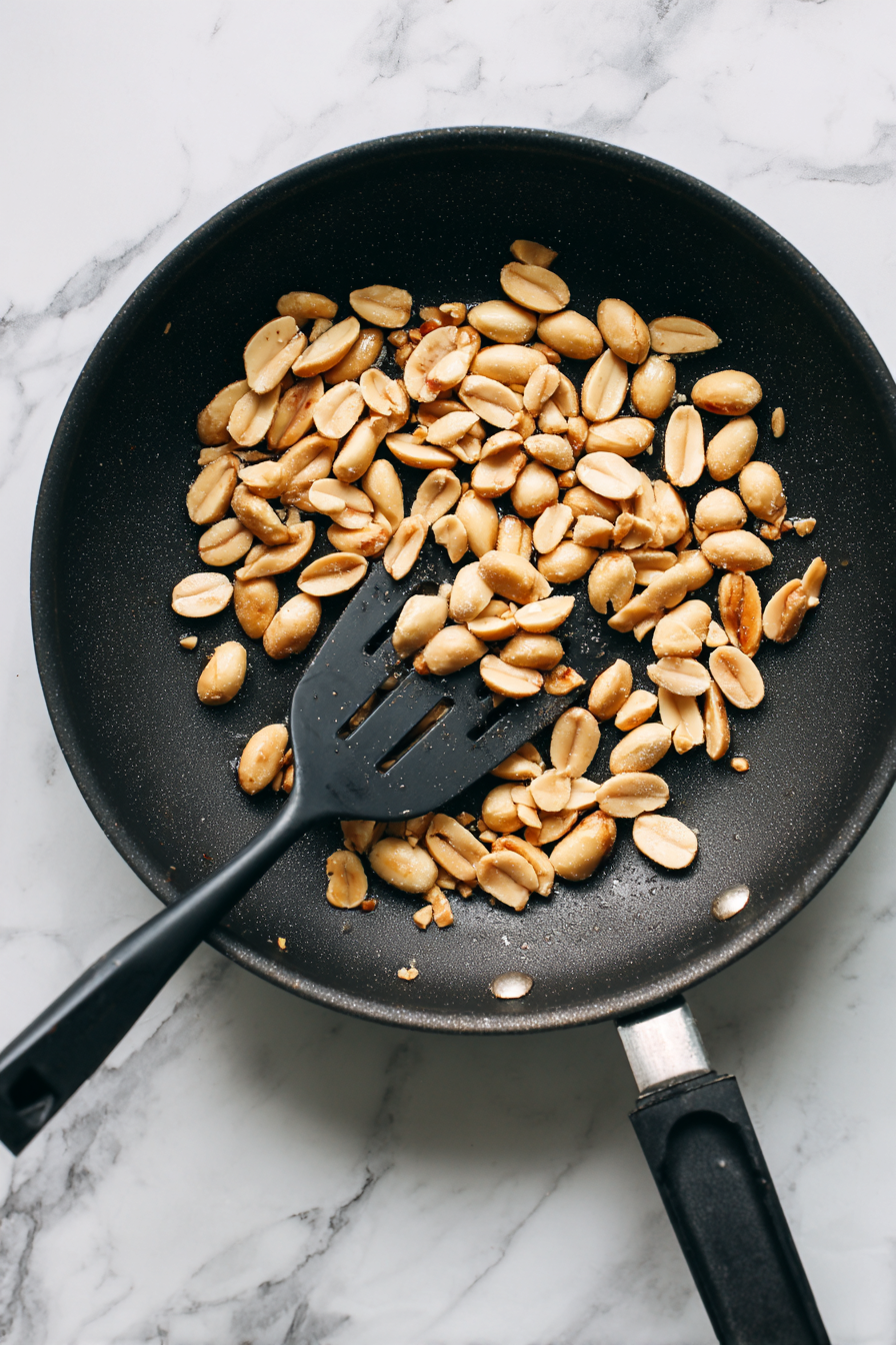 Heat 1 tbsp oil in a pan. Add peanuts and roast till golden. Set aside.