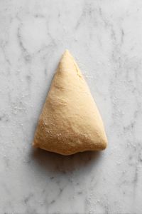 Divide dough into balls and roll into ovals; cut each oval in half.