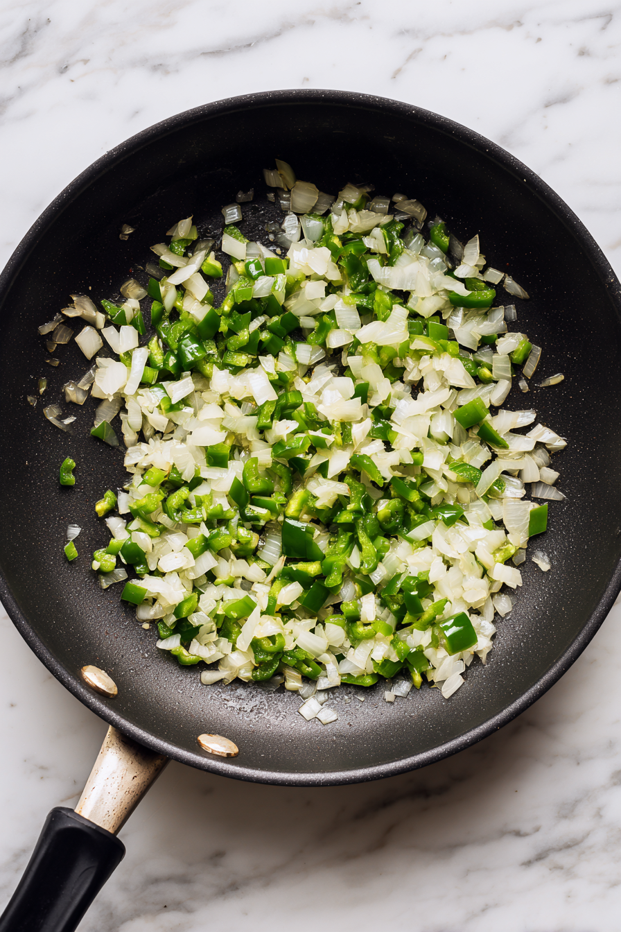 Add chopped green chilies and onions. Sauté till onions are soft.