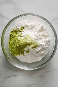 Sift dry ingredients (flour, sugar, matcha, baking powder, salt) into a bowl.