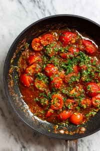 Add chopped tomatoes and cook until soft and masala leaves oil.