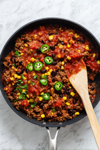 Stir in black beans and corn, then pour the mixture into a greased 9x13-inch baking dish.
