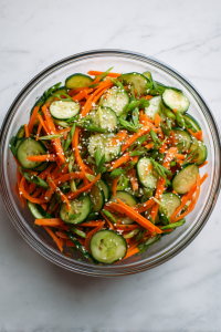 Toss the sliced veggies and sesame seeds into a large bowl.